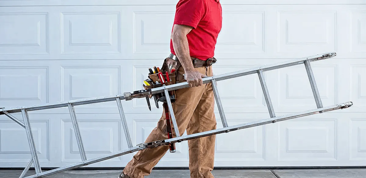 Garage door repair technician arriving with tools and ladder in Pueblo, CO