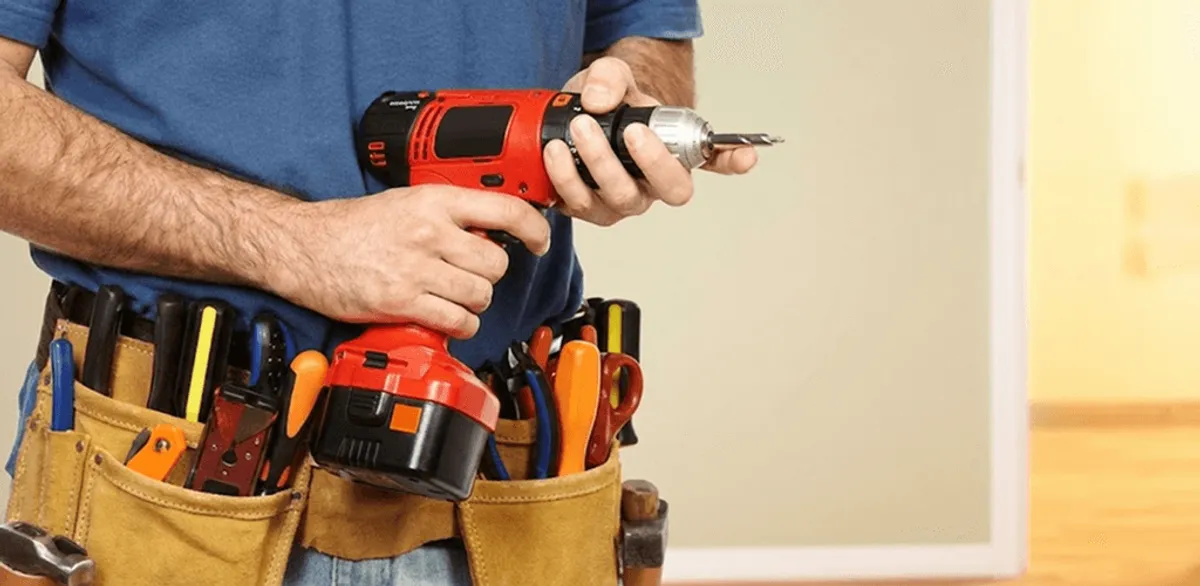 Handyman holding a power drill for home repairs and installations in Pueblo, CO